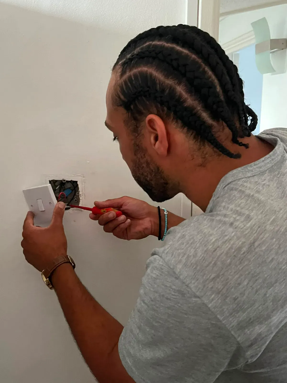 Instructor demonstrating how to safely replace a light switch in a DIY skills workshop